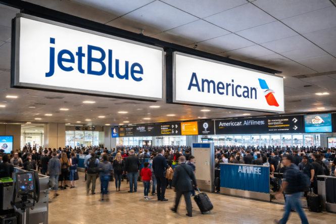busy airport terminal with jetblue and american airlines signs