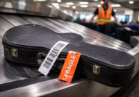 fragile guitar case on airport baggage carousel