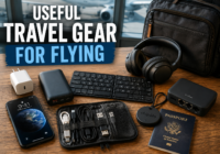 Useful travel gear for flying including charger, power bank, headphones, luggage tracker, travel keyboard, and cable kit