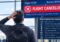 Traveler at an airport looking at a canceled flight notice and common reasons flights get canceled