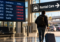 Traveler leaving an airport for the rental car area after multiple flight cancellations, illustrating whether an airline will pay for a rental car after a canceled flight.